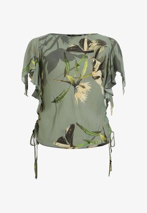 Blouse à manches courtes de couleur vert clair, ornée d'un imprimé floral en noir, beige et vert. Manches à volants et détails à cordon sur les côtés.