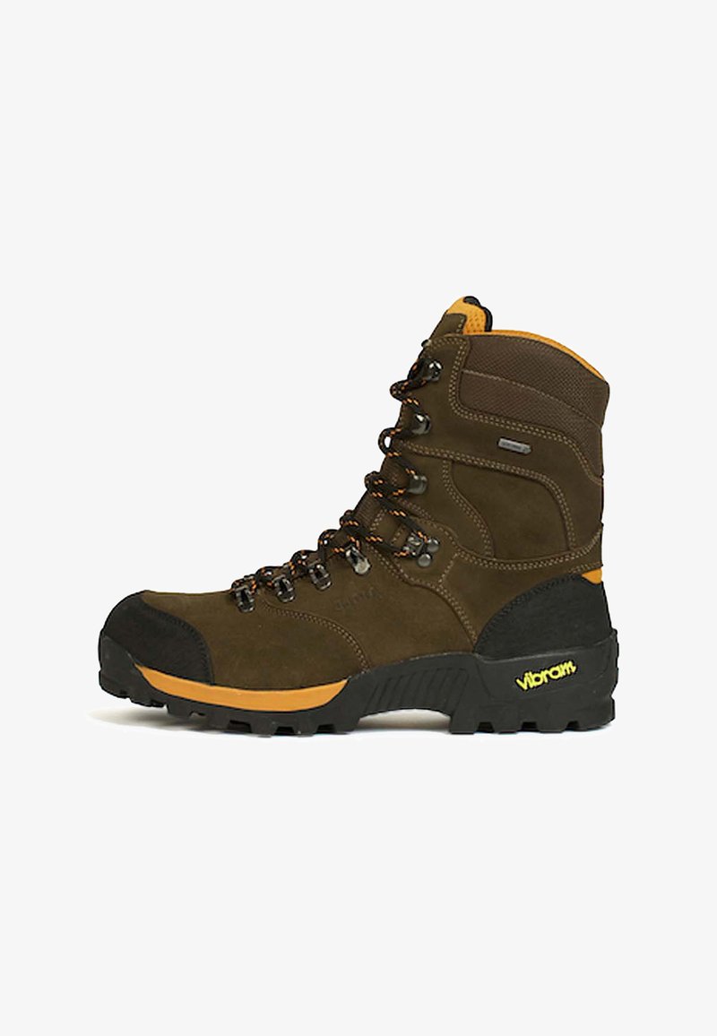 Botte de randonnée montante marron avec bout renforcé noir, accents orange, semelle Vibram robuste, et lacets noirs et orange.