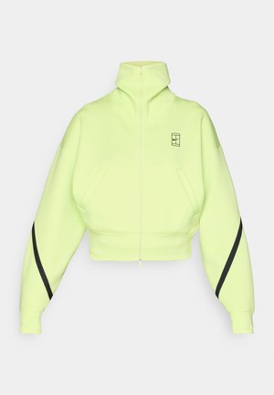 Skraćeni dukserica s patentnim zatvaračem, fluorescentno žuta tkanina, visoki ovratnik, oversized rukavi, bočne džepove, crne pruge na akcentima rukava.