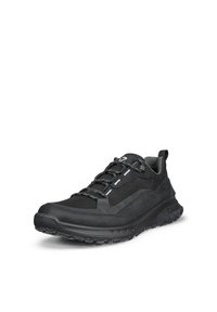 Black low-top athletic shoe with textured sole, padded collar, and reflective details on laces and side panel.