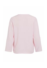 Chemise rose clair à manches longues avec un tissu subtilement texturé, vue de dos avec un col rond simple.