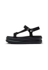 Svarta sandaler med en tjock, texturerad sula, justerbara nylonremmar och en minimalistisk design. Inga synliga logotyper eller mönster.