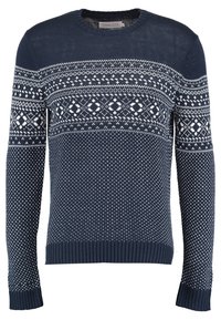 Mörkblå stickad tröja med långa ärmar, prydd med vita geometriska mönster samt ribbade muddar och fåll. Rundhalsdesign.