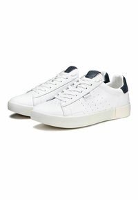 Sneaker bianche in pelle con design perforato, punta tonda, suola in gomma bianca e dettagli blu scuro sul tallone e sulla linguetta.