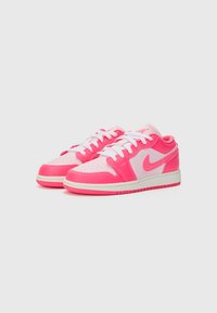 Pink and white low-top sneakers with a smooth leather upper, mesh panels, white laces, and a rubber sole featuring a textured pattern.