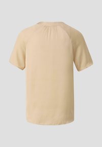 Chemise à manches courtes, jaune pastel, avec une coupe décontractée, un col arrondi et des fronces à l'arrière. Texture lisse, sans motifs visibles.