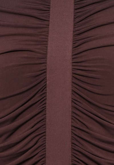 Close-up of dark brown fabric with gathered texture on both sides and a smooth vertical ribbed strip in the center.