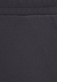 Navy blue fabric with a smooth, ribbed texture. Visible seam at the top, indicative of a fitted garment design. No patterns or accents present.
