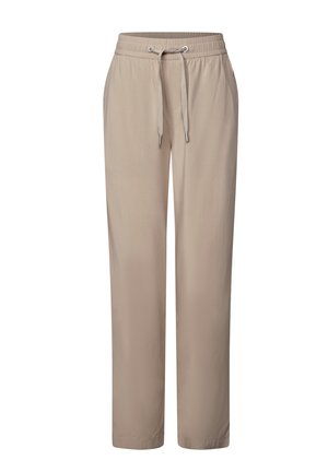 Beige avslappnade byxor i lös passform tillverkade av slitstark och mjuk tyg, med elastisk midja och dragsko. Rak ben med inga mönster.