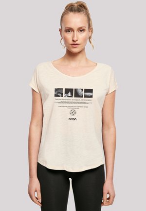 Cream, loose-fit t-shirt with a round neckline. Front features NASA logo and black-and-white space imagery in rectangular sections. Soft texture.