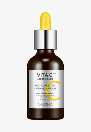 Brun glas pipetteflaske med sølvhætte, gul pipette og hvid etiket med sort tekst og en gul cirkel. Indeholder 30 ml produkt.