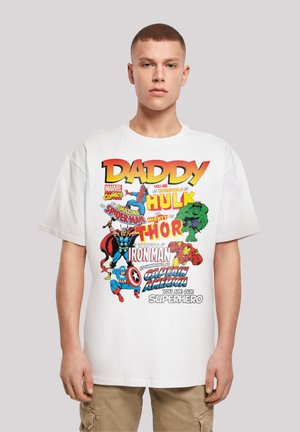 White cotton t-shirt featuring colorful comic-style graphics of Marvel characters and text, with a crew neck and short sleeves.
