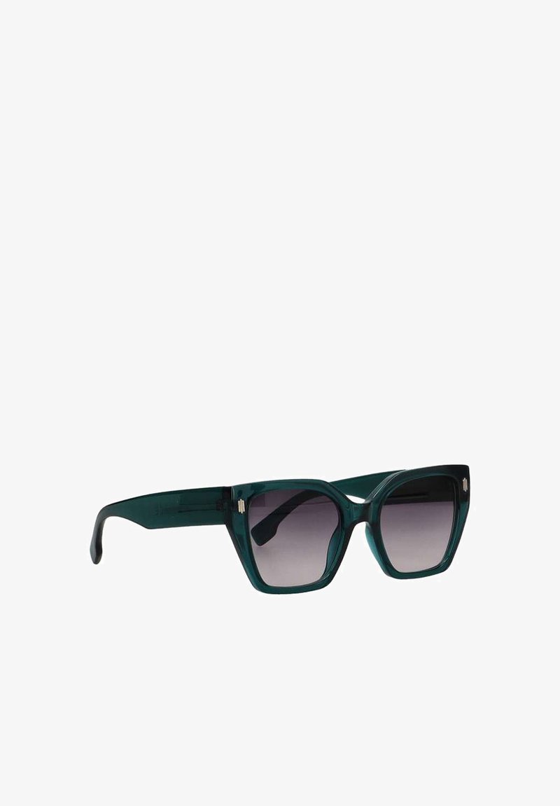 Gafas de sol de plástico verde y translúcido con una forma de ojos de gato atrevida. Las lentes de tono degradado y los acentos de hardware plateado completan el diseño.