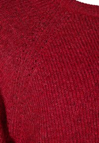 Red knitted sweater featuring a textured surface, ribbed neckline, and diagonal stitching pattern. Made from soft, warm fabric.