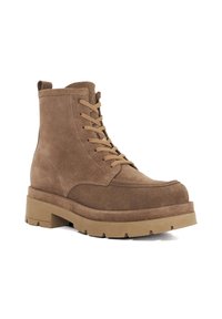 Brown suede ankle boots with a thick chunky sole, featuring round toe and lace-up front. Soft texture with reinforced stitching details.