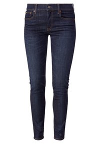 Mörkblå denimjeans med smal passform, femfickorsdesign och kontrasterande sömmar. Har en knäppning och bälteshällor.