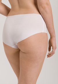 White cotton hipster underwear with a smooth texture, mid-rise design, and minimal seams, showcasing a simple, classic silhouette.
