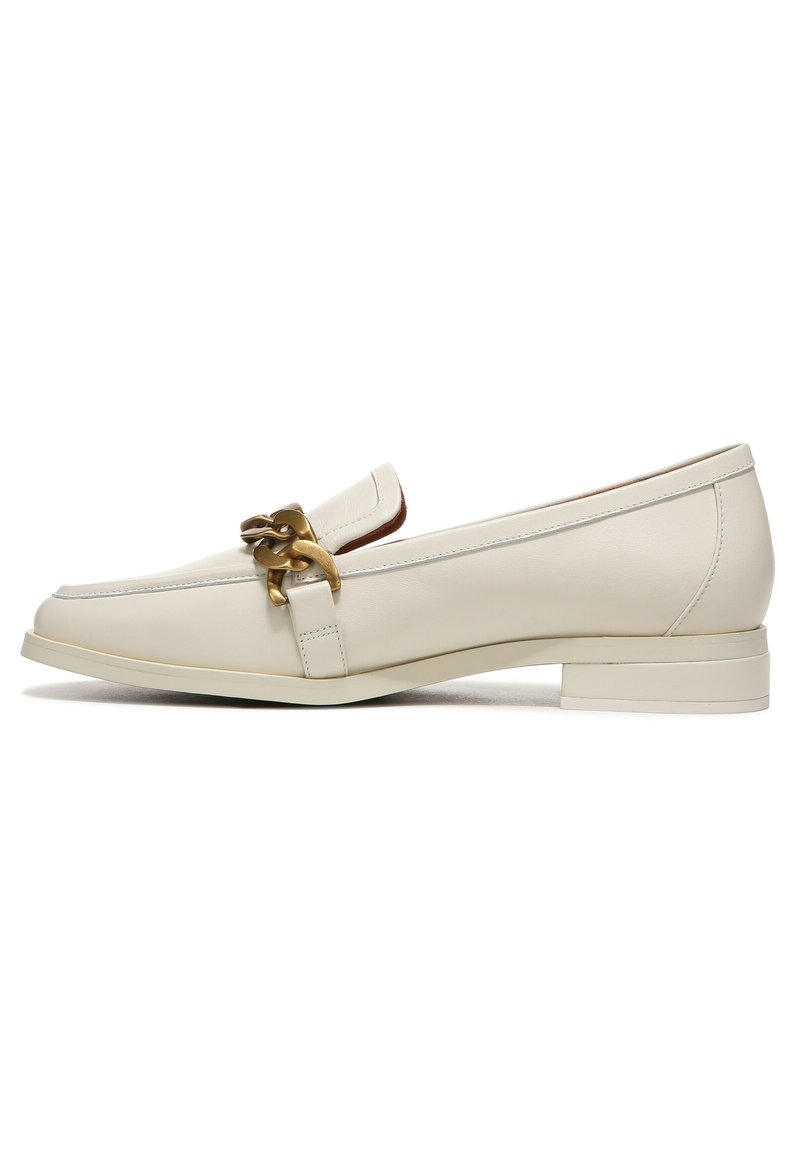 Light beige leather loafers with a low block heel, featuring a decorative gold chain accent and clean stitching details.