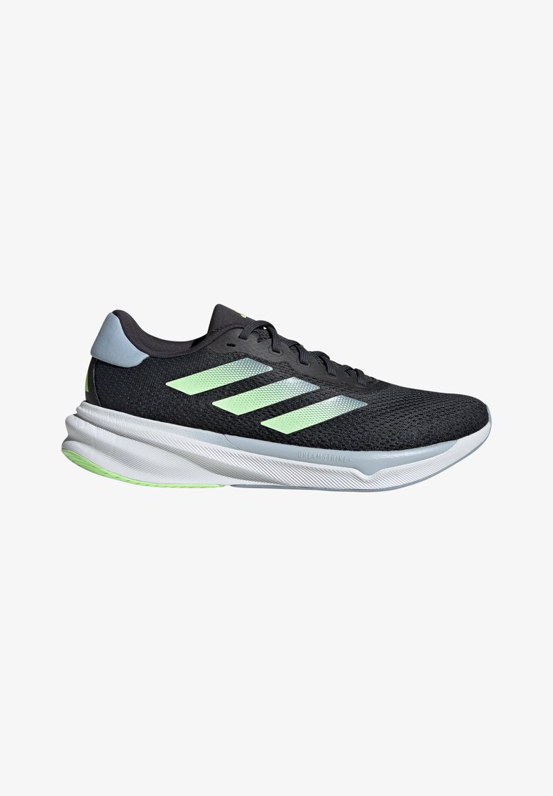 Black athletic shoes with a mesh upper, featuring three light green stripes, a grey heel accent, and a white textured sole.