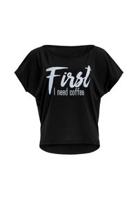 Black short-sleeve t-shirt featuring a round neckline and a loose fit. The front displays the text "First I need coffee" in white lettering.