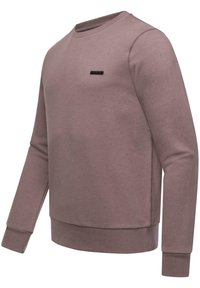 Jasnofioletowy sweatshirt wykonany z mieszanki bawełny, z okrągłym dekoltem, długimi rękawami, ściągaczami w mankietach oraz małą czarną naszywką z logo na piersi.