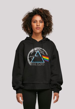 Black hoodie featuring a graphic of a prism and rainbow colors, with "PINK FLOYD" text in white, and a textured, relaxed fit.