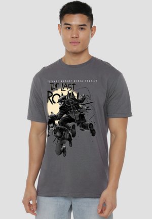 Gray cotton t-shirt featuring a black and white graphic of characters from "Teenage Mutant Ninja Turtles" with text "The Last Ronin."
