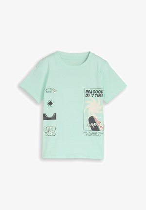 T-shirt bleu clair avec graphisme skateboard, motifs en spirale et texte incluant "Let's ride", "Good time" et "All along the skatepark."