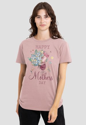 Light pink cotton t-shirt featuring an illustration of a character holding a bouquet, with "Happy Mother's Day" text in burgundy script.