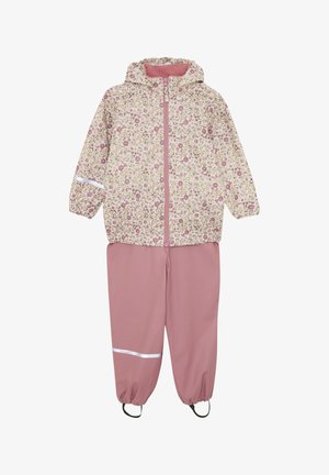 Wasserdichter Regenmantel mit floralem Muster in Creme, kombiniert mit pinken wasserdichten Hosen mit elastischen Bündchen und reflektierenden Akzenten.