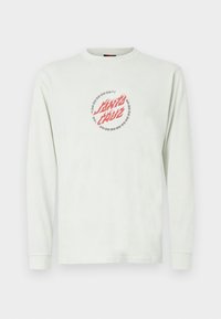 Light green long-sleeve t-shirt made of cotton. Features "Santa Cruz" graphic inside a barbed wire circle in red and white.