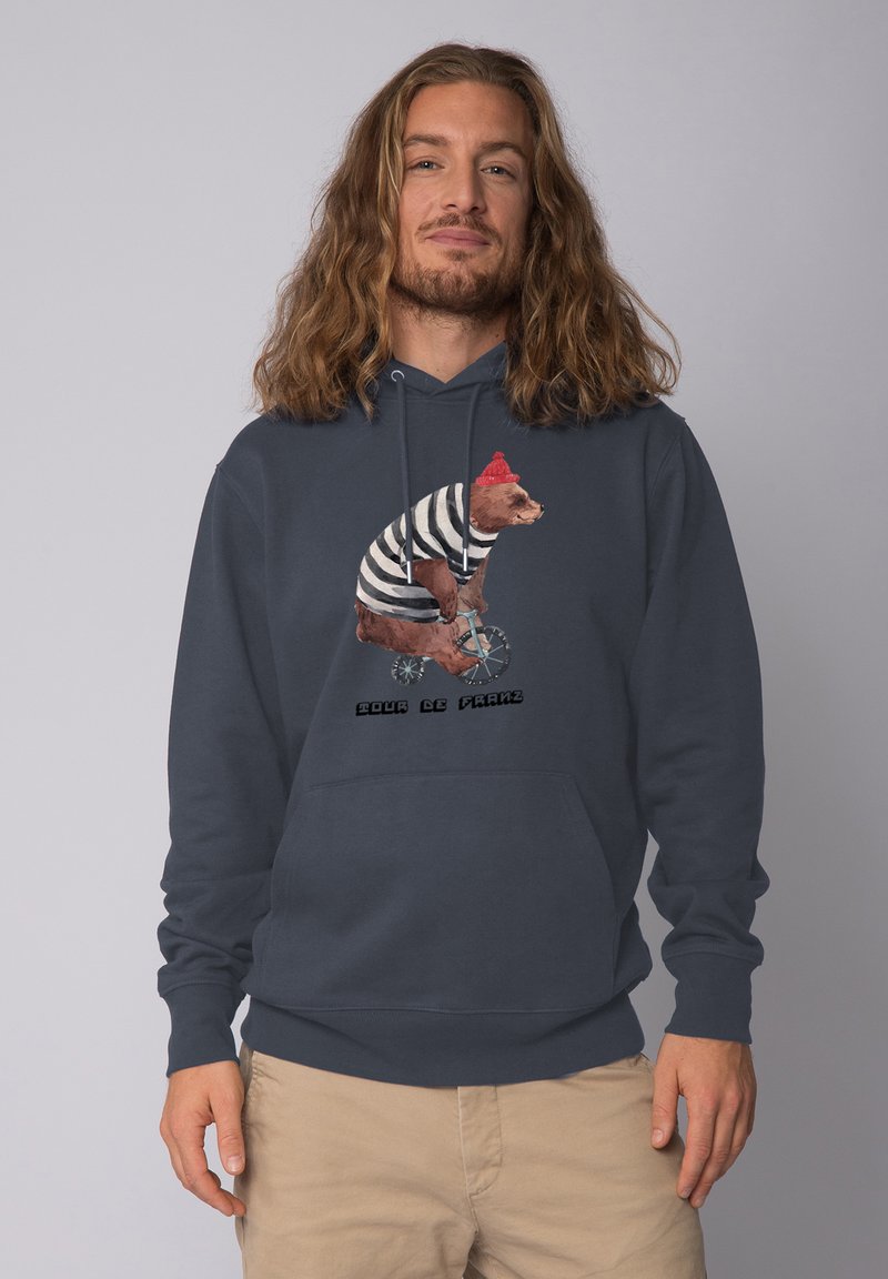 Marineblauwe hoodie van katoen, met een beer in een gestreept shirt en een rode hoed die op een fiets rijdt, met de tekst "Pour le France" eronder.