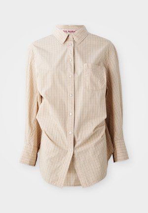 Beige long-sleeve button-up shirt with a checked pattern, features a collar, pocket on the left side, and white buttons.