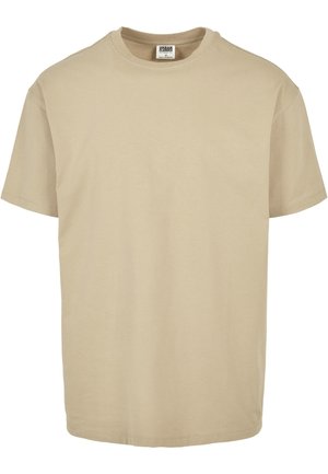 Camiseta de algodón beige con cuello redondo, mangas cortas y dobladillo recto. Textura suave, diseño sencillo, sin patrones ni adornos.