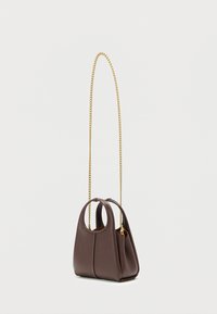 Brown leather handbag with a structured shape, featuring a gold chain strap and rounded handles. Textured surface with a seam detail.