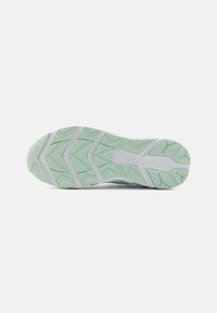 Light green and white rubber shoe sole with geometric tread pattern, shown flat on a white background.