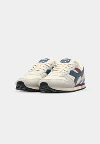 Beige sneakers with a mix of suede and mesh. Features navy, maroon, and grey accents. Rubber sole with a textured pattern. Lace-up closure.