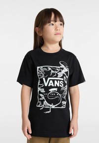 Schwarzes Baumwoll-T-Shirt mit weißen Dinosaurier-Skelettgrafiken und "VANS OFF THE WALL"-Text in der Mitte. Kurze Ärmel, Rundhalsausschnitt.