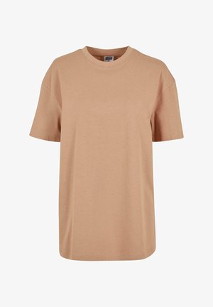 Beige pamut póló, laza szabással, rövid ujjakkal és kerek nyakkivágással, sima textúrával és minimális varrási részletekkel.