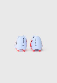 Light blue and red soccer cleats with a smooth texture, featuring a distinct logo and raised heel. Studded outsole designed for traction.