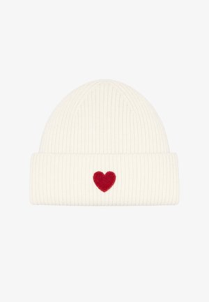White knit beanie with ribbed texture and a folded cuff, featuring a small red heart embroidered on the front.