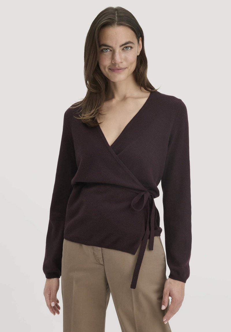 V-Ausschnitt Wickelstrickpullover in Dunkelburgunder, hergestellt aus weichem Stoff. Verfügt über lange Ärmel und einen Bindegürtel in der Taille sowie eine glatte Textur.