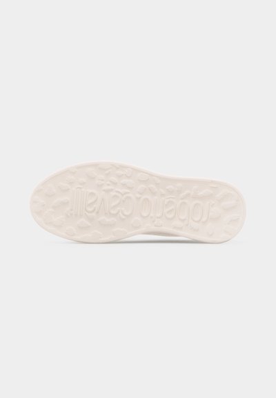 Λευκή σόλα παπουτσιού με ανάγλυφα ανομοιόμορφα σχήματα και ανυψωμένο κείμενο με το όνομα της μάρκας στο κέντρο, φωτογραφημένη πάνω σε απλό φόντο.