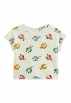 Haut à manches courtes en tissu doux, avec un fond crème et des motifs de coccinelles colorées en rouge, vert, orange et jaune.