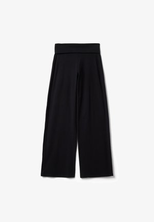 Pantalon noir à jambes larges avec une taille haute repliée, posé à plat sur un fond blanc.