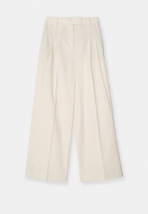 Wide-leg trousers in textured cream fabric. Features a high waist with pleats, belt loops, and a clean, minimal design.