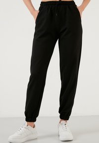 LELA - Tracksuit bottoms - black Thumbnail Image 1