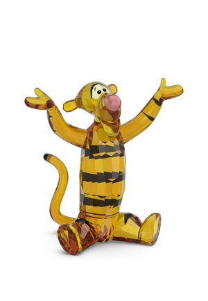 Kristallfigur von Tigger aus Winnie Puuh, sitzend mit erhobenen Armen, leuchtend gelb mit schwarzen Streifen und rosa Nase.