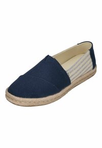 Navy canvas slip-on shoes with a flat design, featuring a woven rope sole and striped side accents. No laces or hardware details visible.