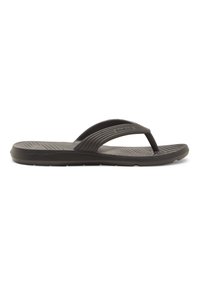 Tongs noires avec une semelle intérieure texturée, des brides douces et une semelle élancée. La bride présente des rainures subtiles pour une meilleure adhérence et un confort accru.